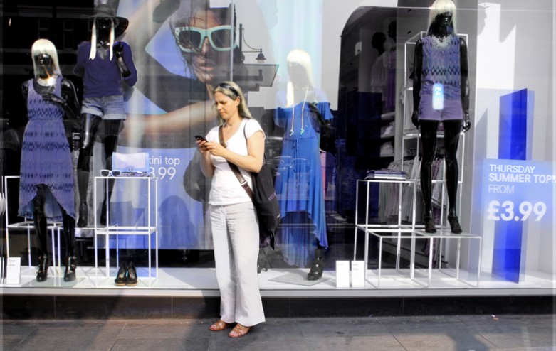 A woman in Blond Zone on Wednesday in front of a Thursday clothing shop